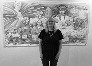 Image of artist Maria Driscoll McMahon standing in front of one of her drawings